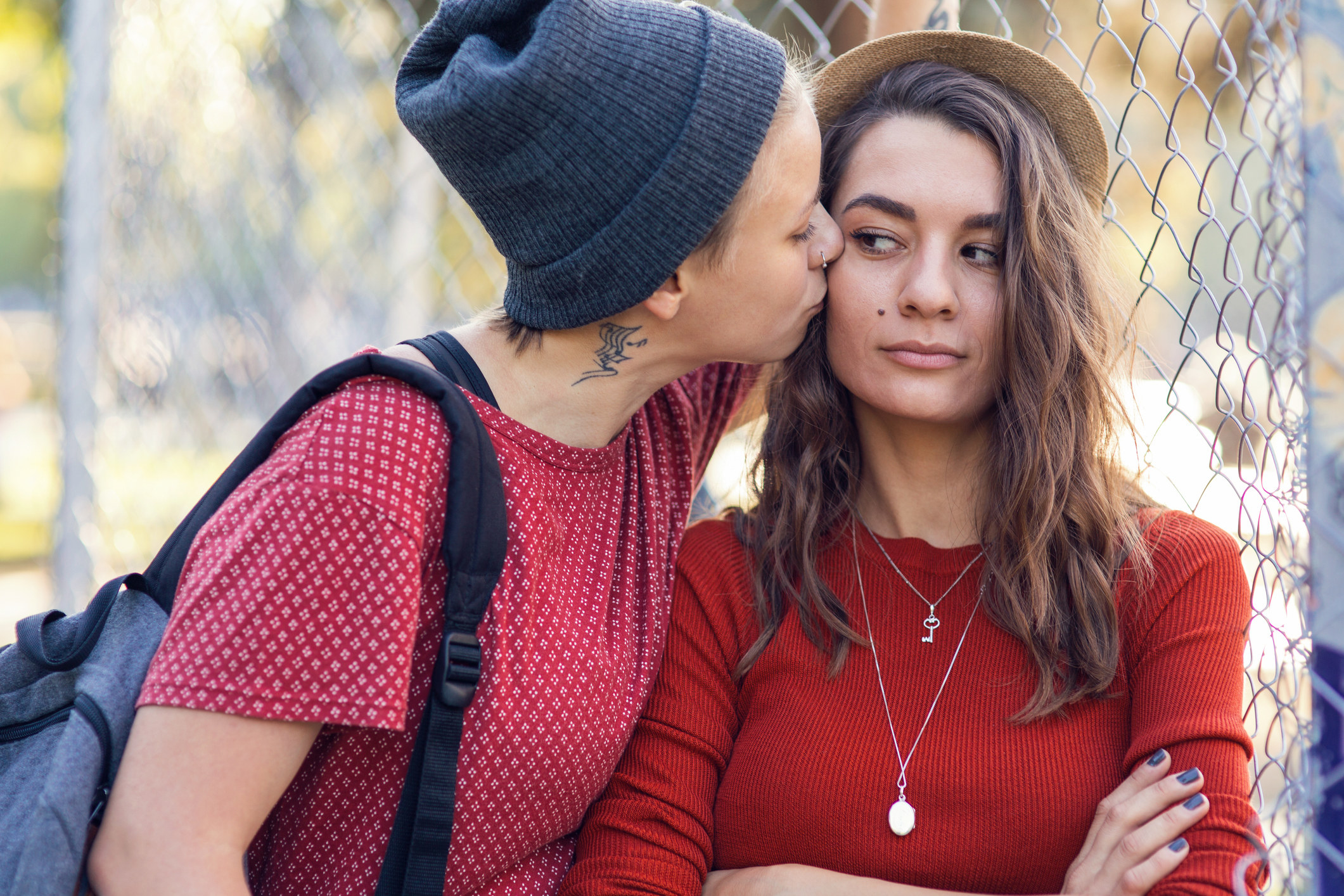 woman kissing another woman on the cheek