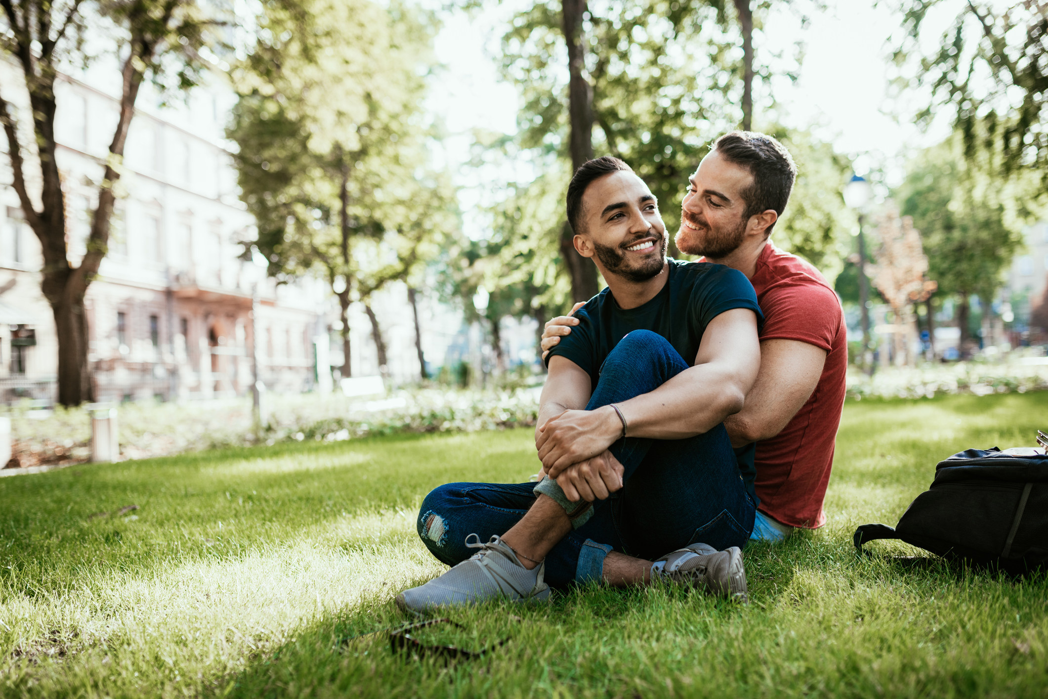 two men hugging each other at the park