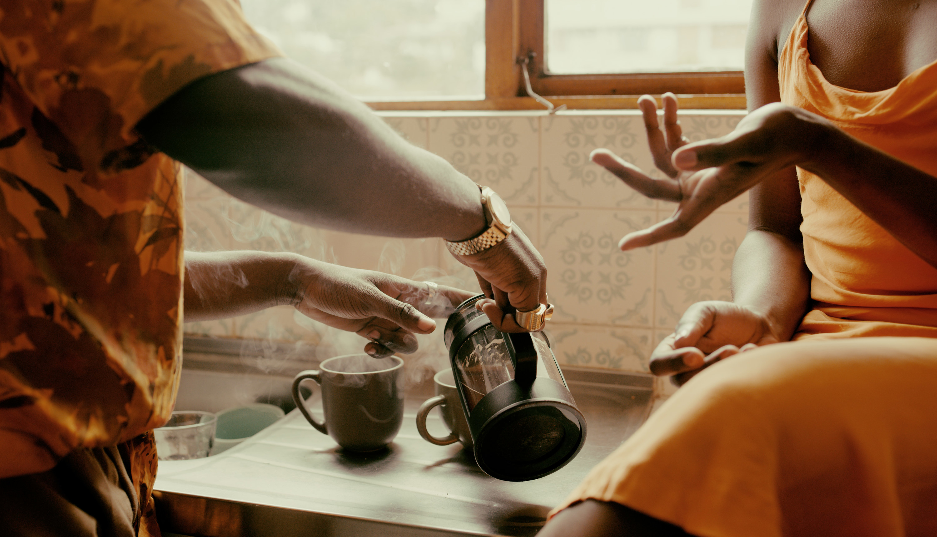 couple making coffee and talking in their kitchen
