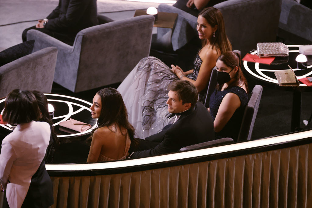 mila and ashton in the audience sitting down