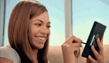 Beyonce laughing while using a tablet