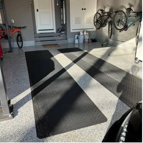 A black rubber garage floor mat