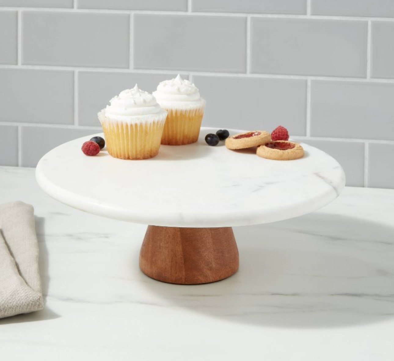 A marble and wood cake stand