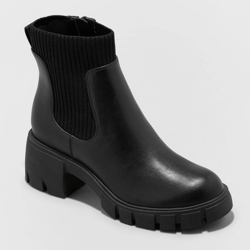 black chelsea boots with lug soles and sock material around the ankle