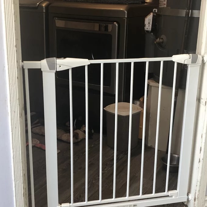 A gate is installed in a door between two rooms