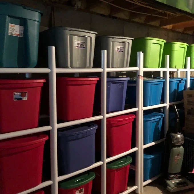 A set of 4-shelf shelving units holding large bins
