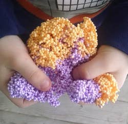 reviewer holding the purple and orange foam in their hands