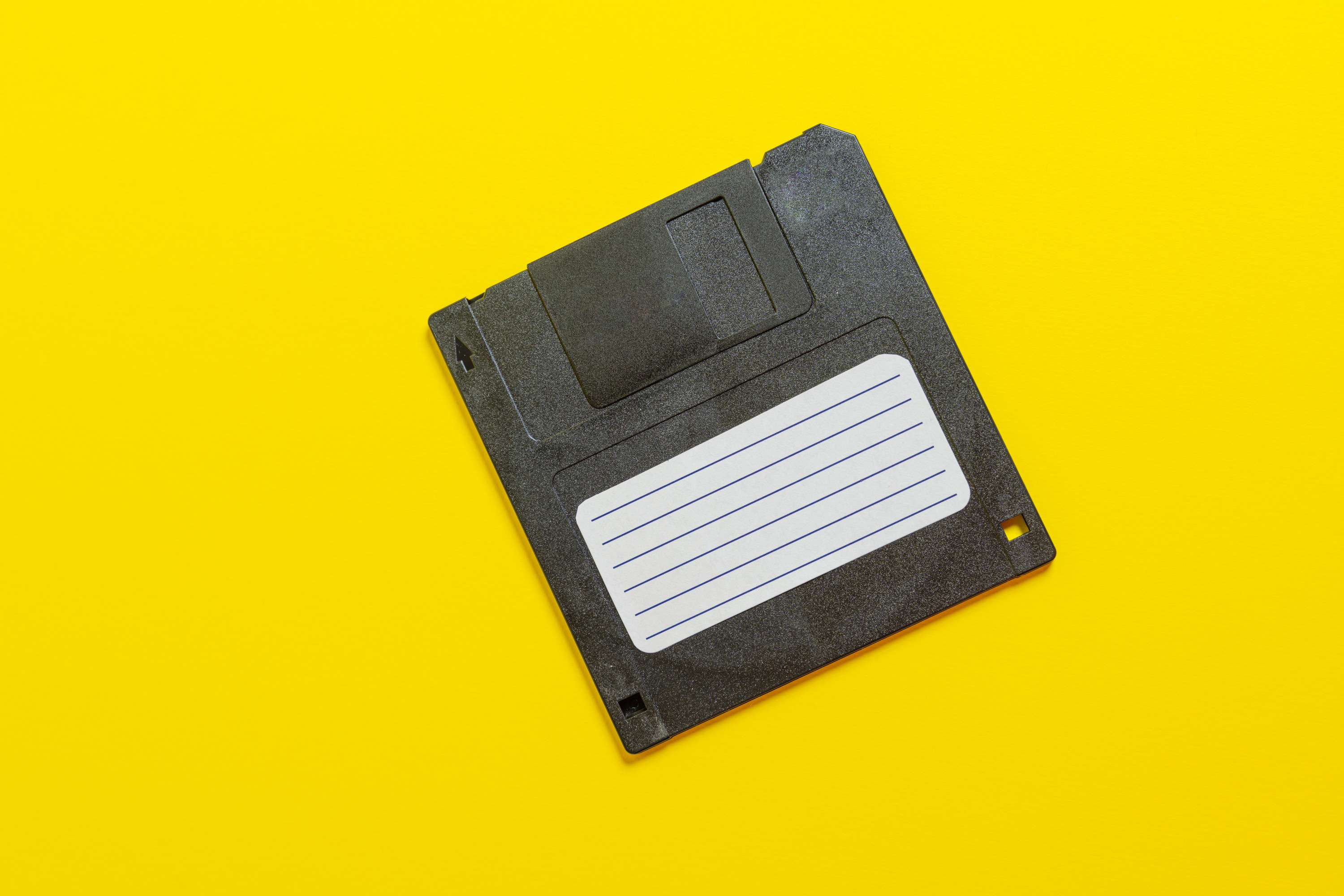 Diskette on the yellow background, symbol of data
