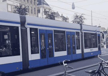 GIF of a tram travelling through the city
