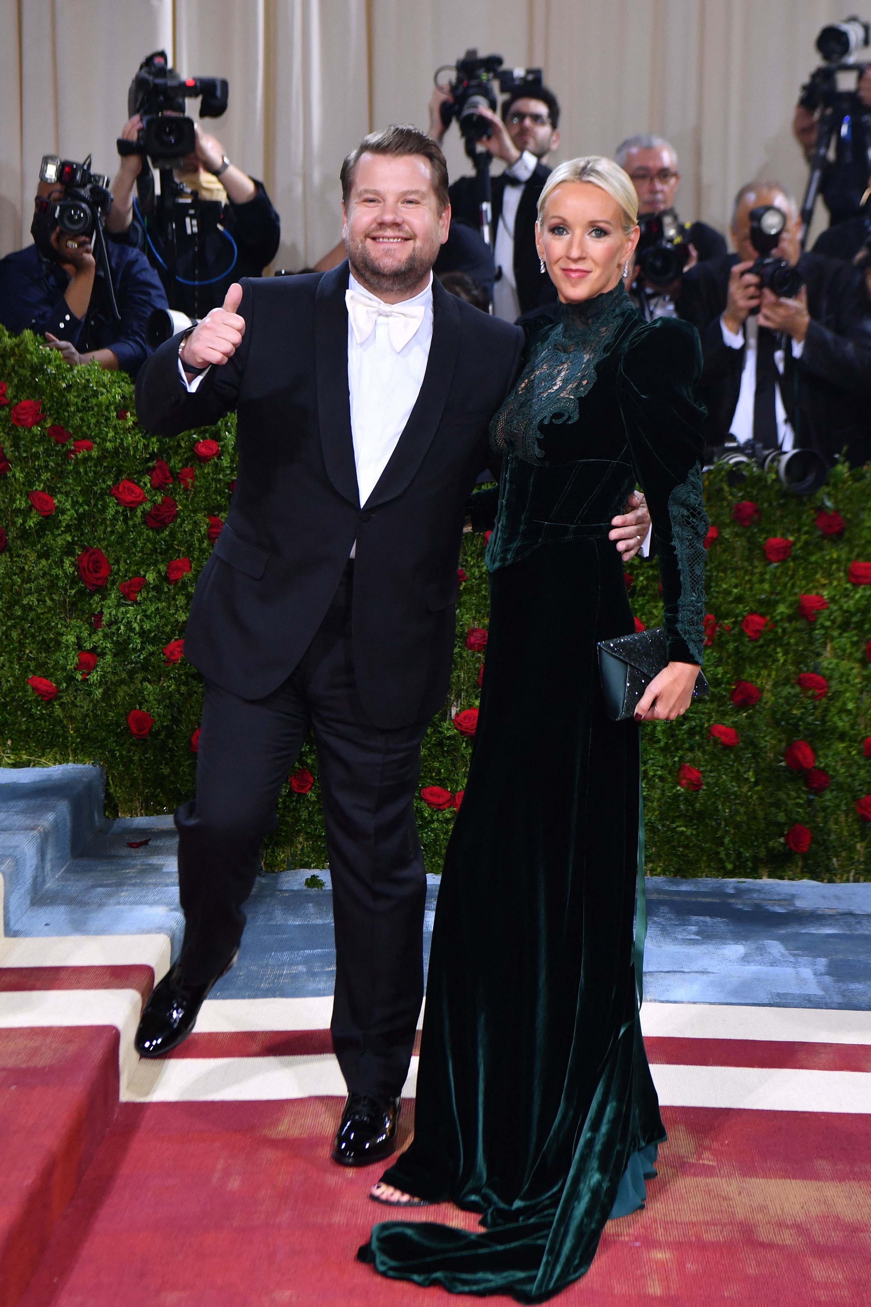 James giving a thumbs up as he and his wife walk the red carpet at an event