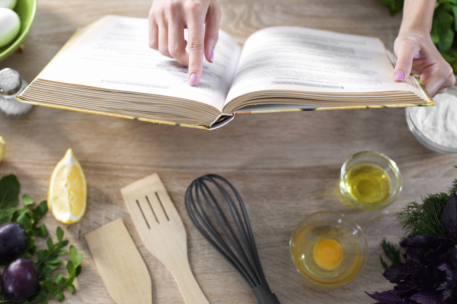 A person looking at a cookbook