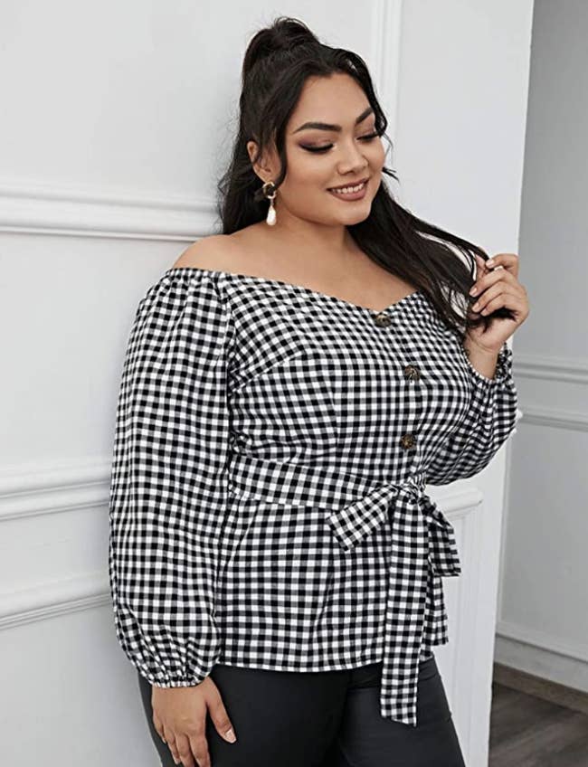 person wearing top in black checker pattern