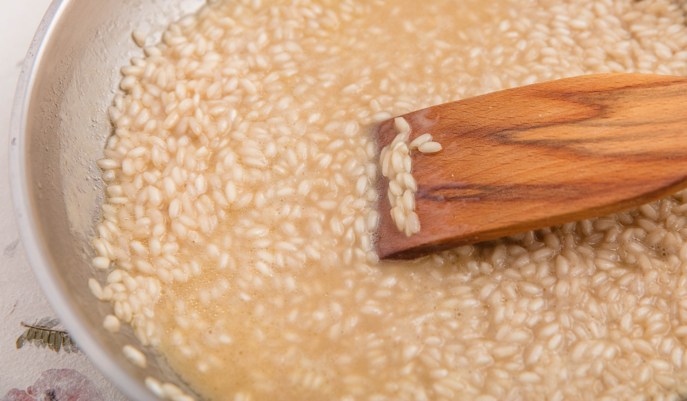Stirring risotto in a pan