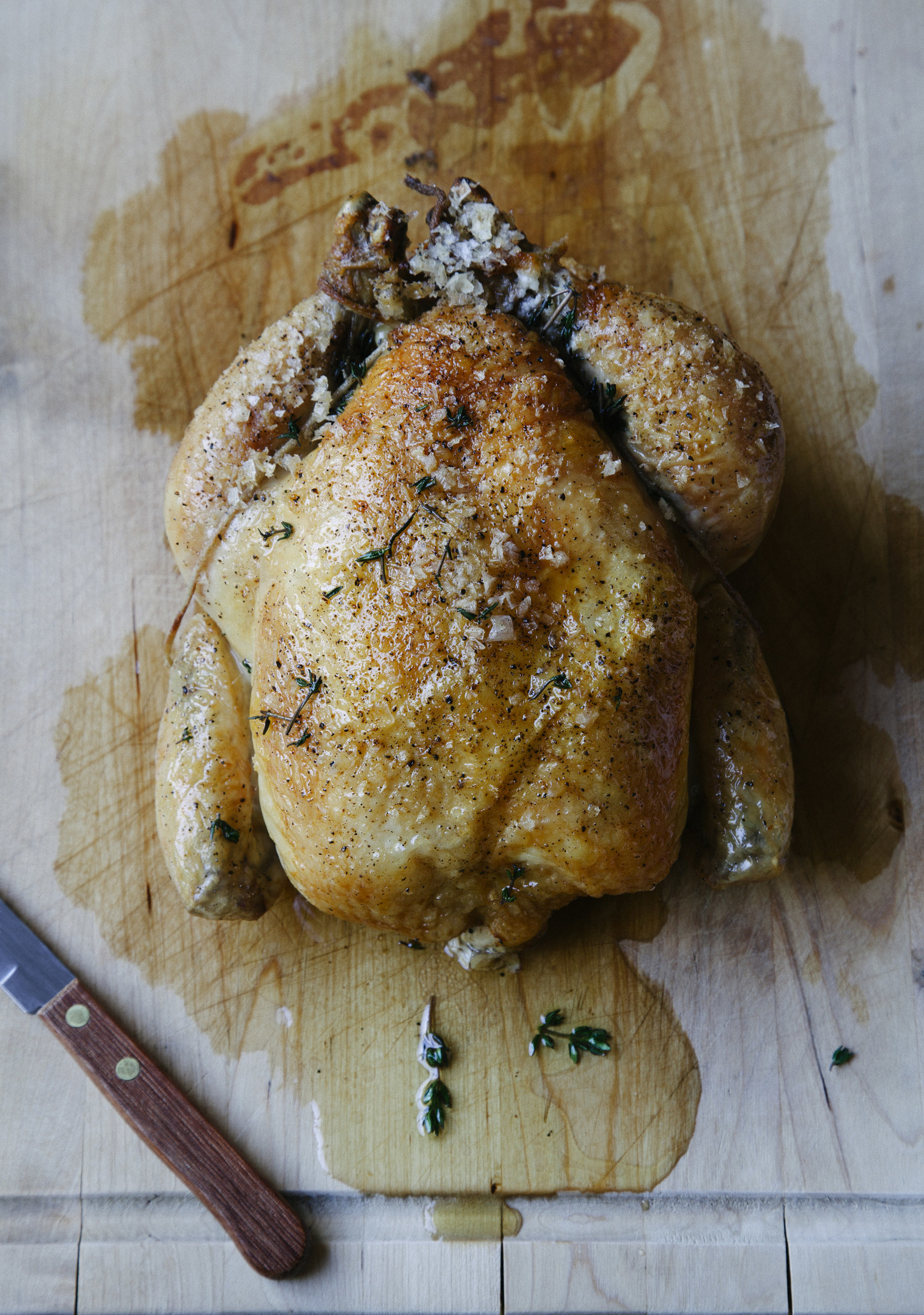 Roast chicken on cutting board.