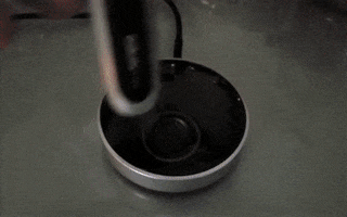 gif of reviewer placing razor on charging dock
