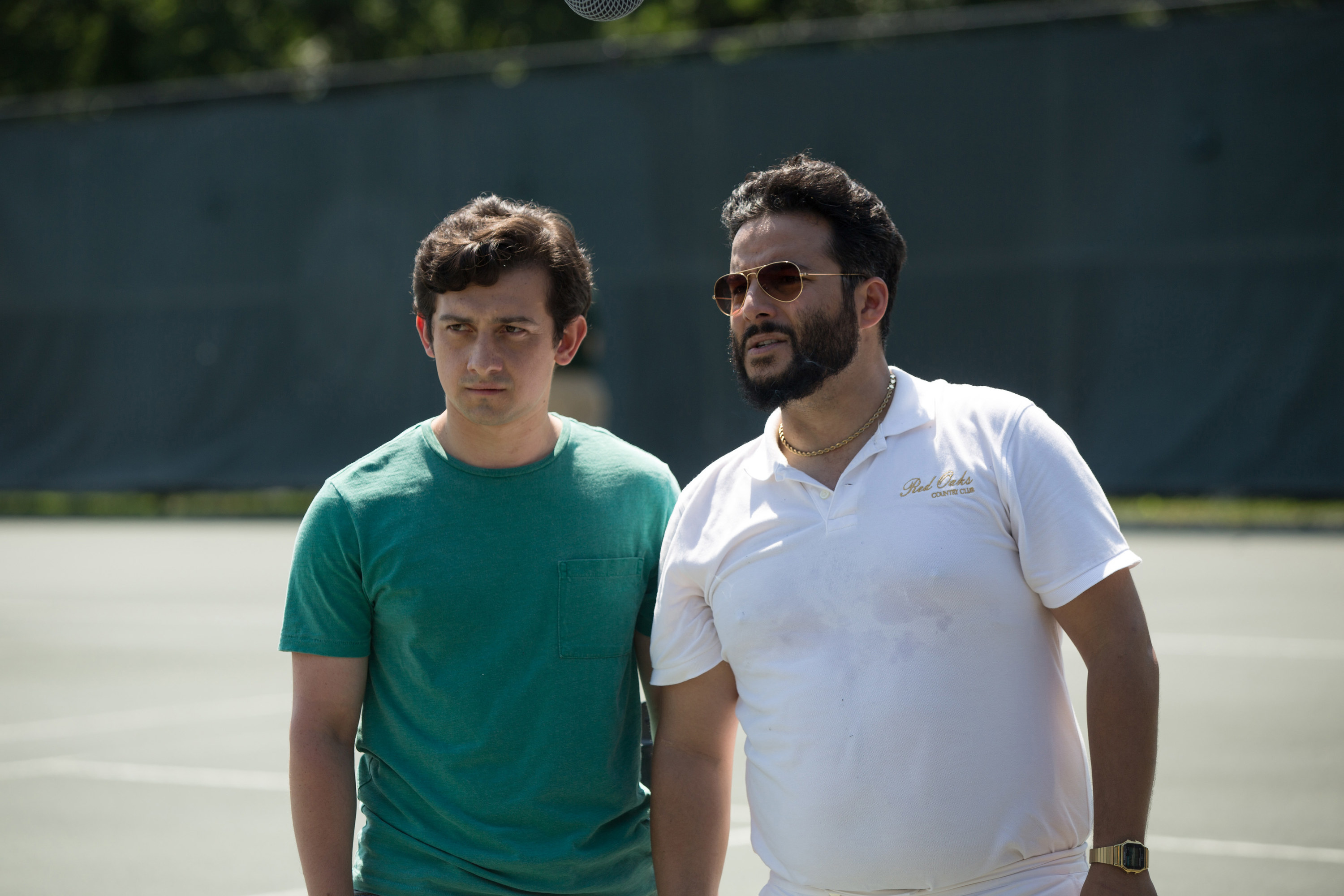 Craig Roberts and Ennis Esmer stand on a tennis court