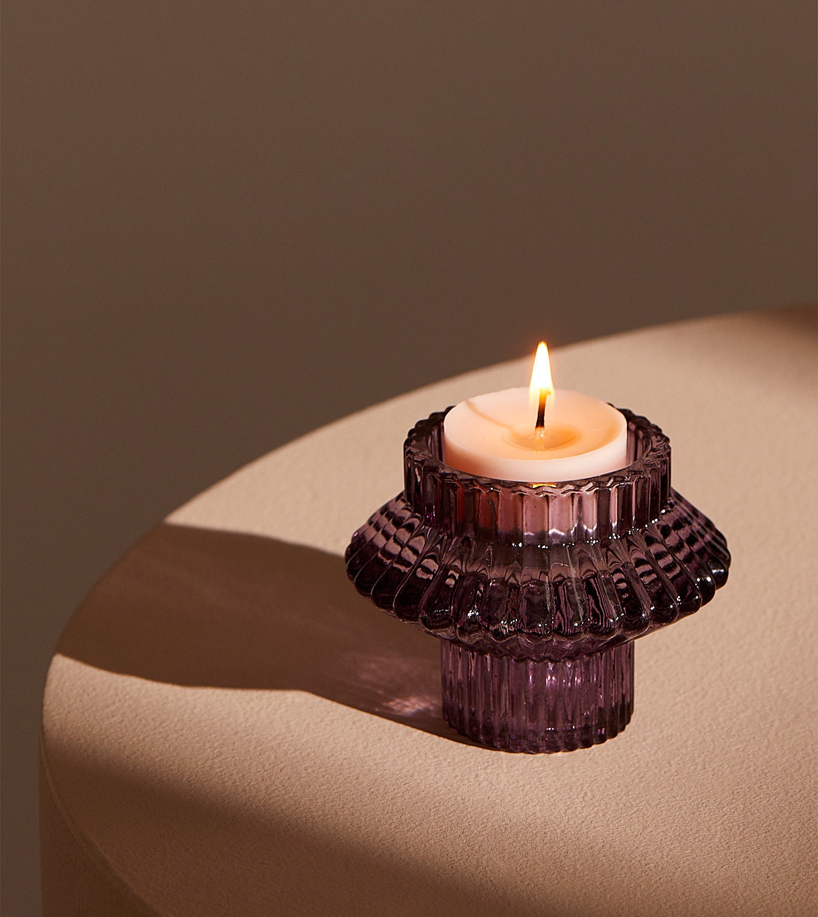 a double ended candle holder holding a tea light