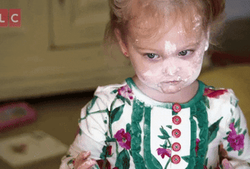 gif of child from tlc europe show outdaughtered with toddler whose face is covered in flour