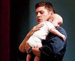 a man comforting a baby