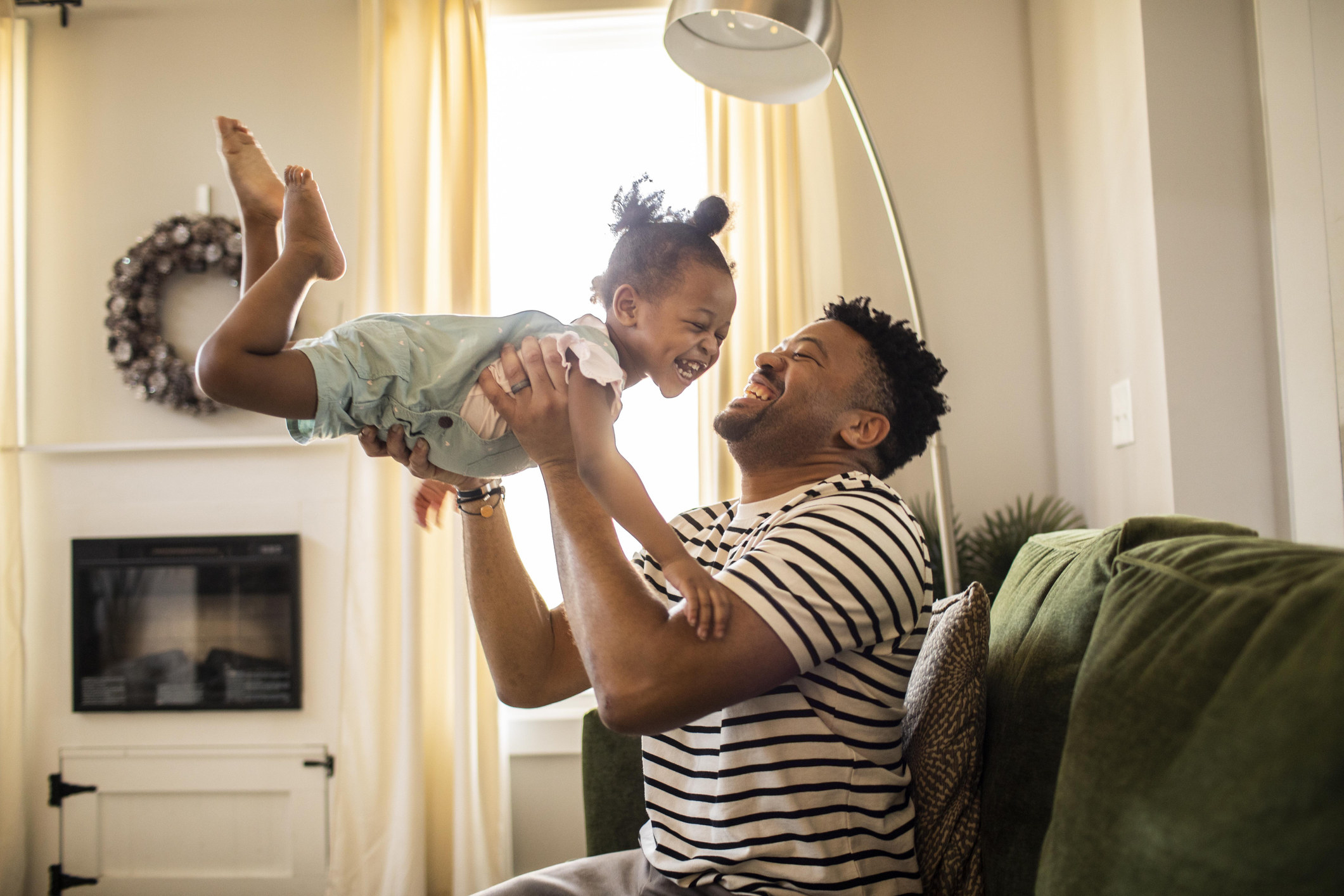 a man playing with his daughter