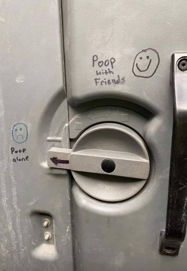&quot;Poop with friends&quot; written in a portable toilet