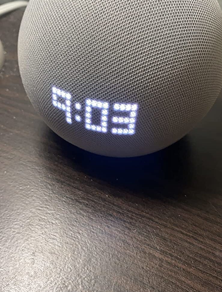 the Echo Dot illuminated with the LED clock display