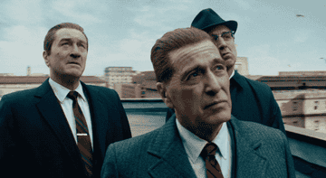 Robert De Niro, Al Pacino, and Ray Romano stand on a rooftop