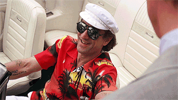 Robert De Niro laughs in a car