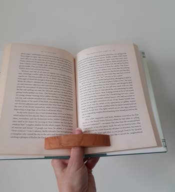 a person reading a book with the page holder