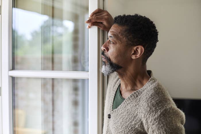 A man staring out his window