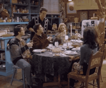 The cast of Friends toast during their Friendsgiving celebration