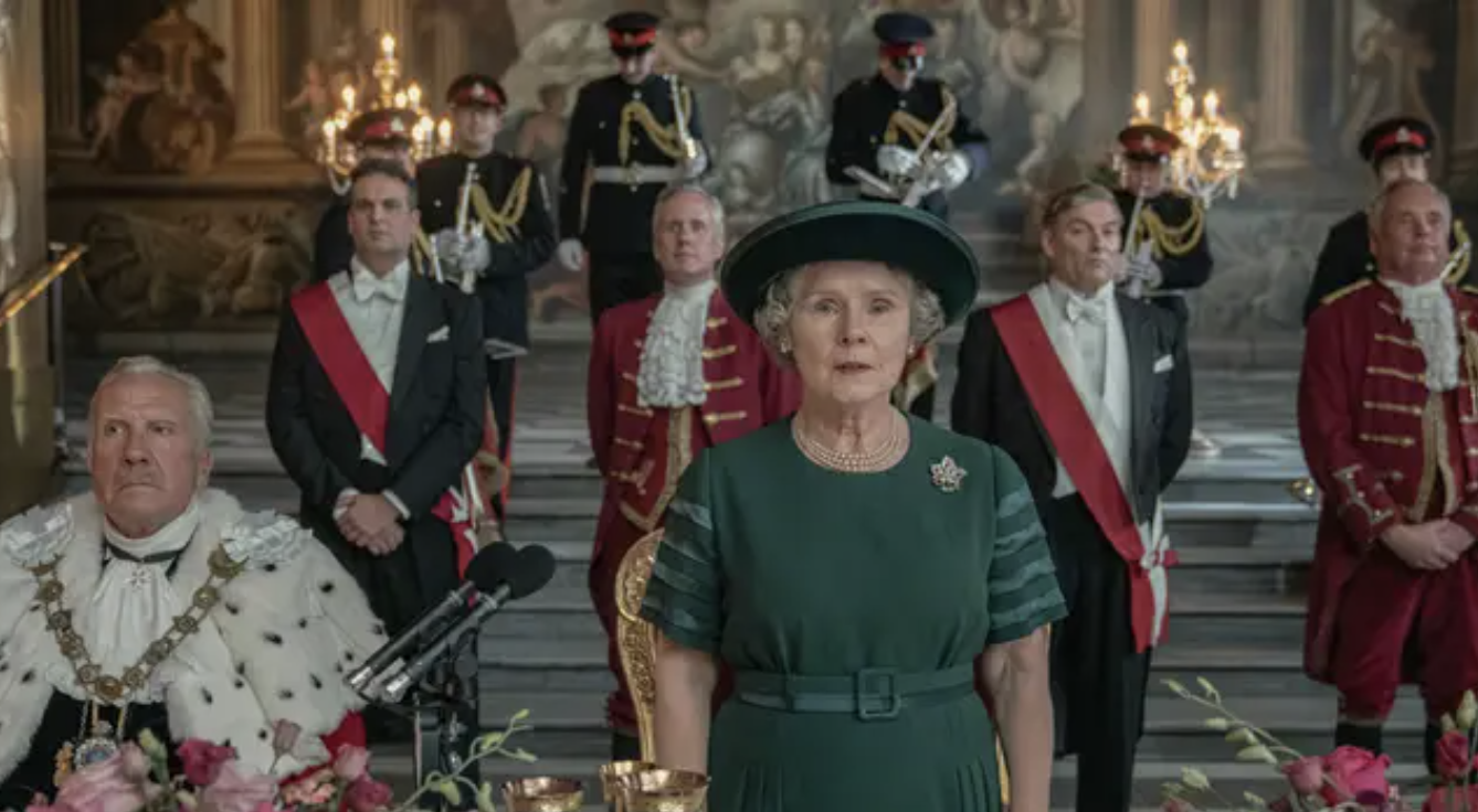A bunch of royal-looking people stand behind Imelda Staunton as the Queen in The Crown