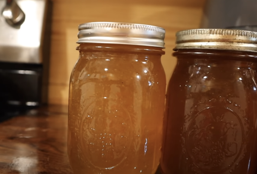 different colors of honey in mason jars