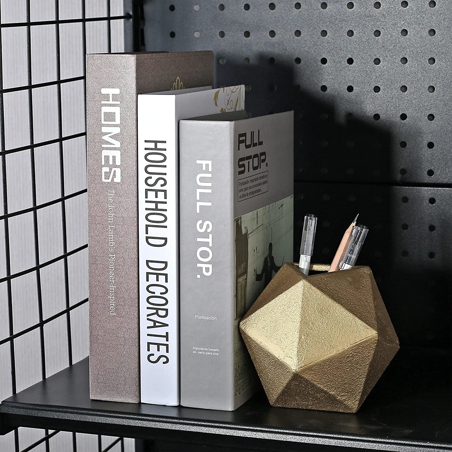 a metallic geometric bookend with pens stashed inside