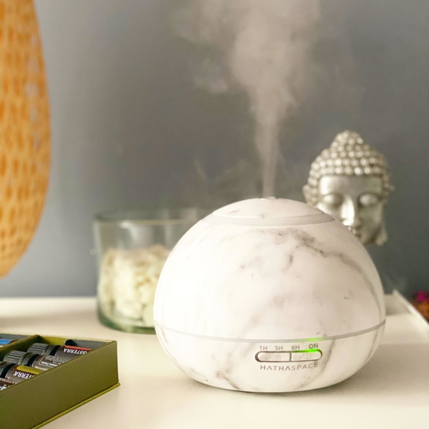 the white essential oil diffuser on a reviewer&#x27;s table