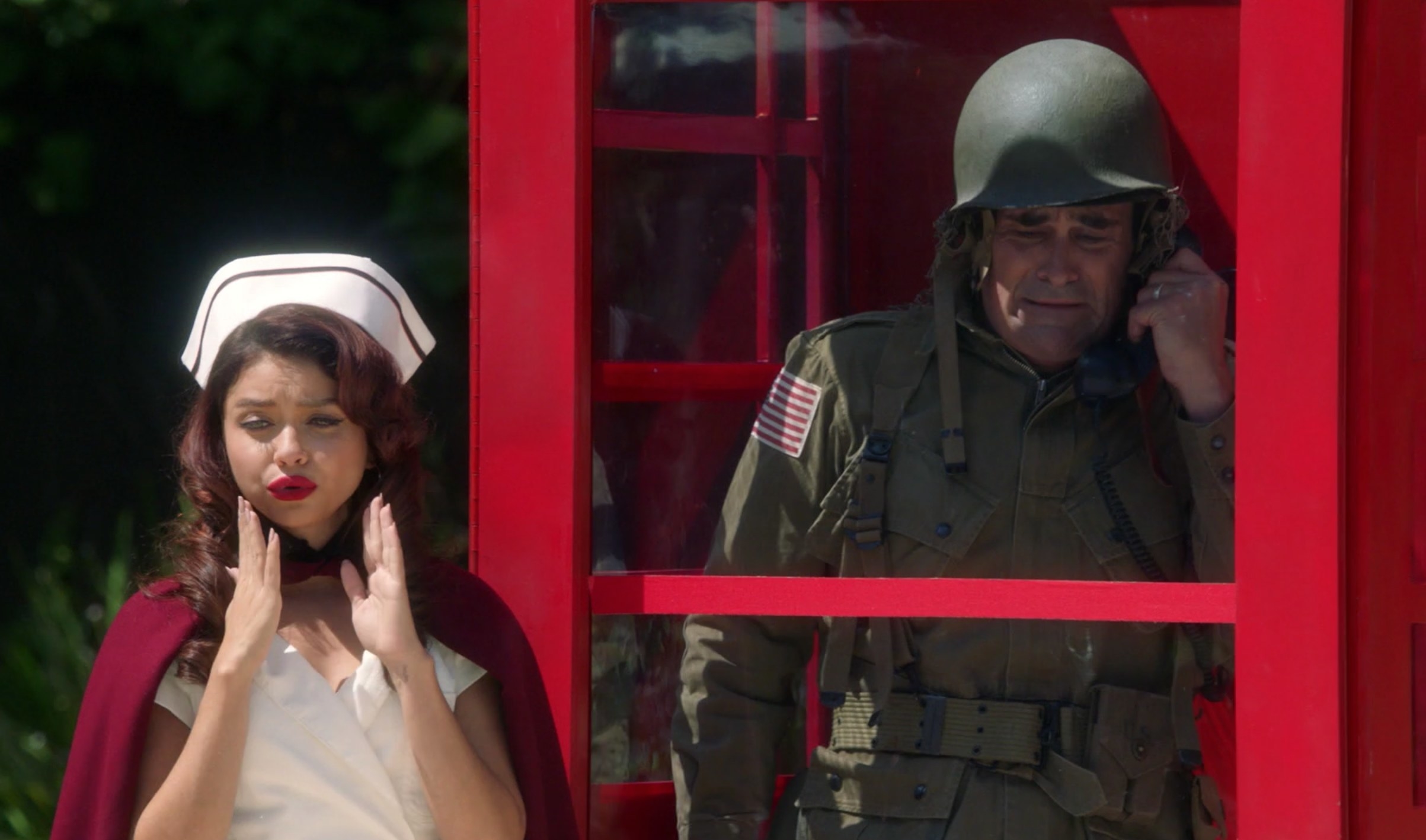 Haley poses next to Phil&#x27;s phone booth while he&#x27;s inside crying