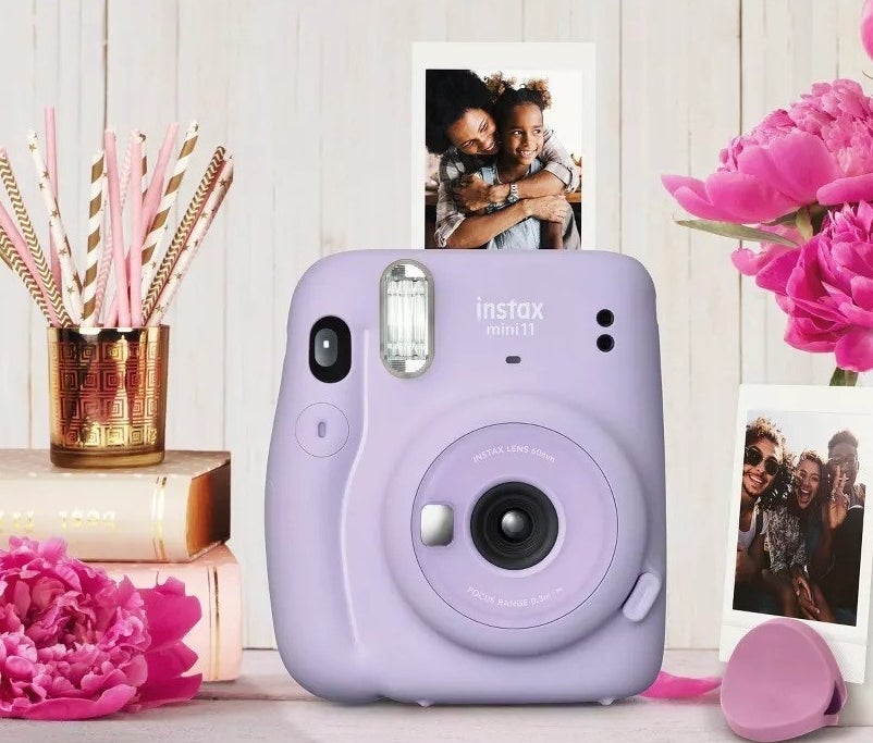 purple Instax Mini11 camera printing out small picture