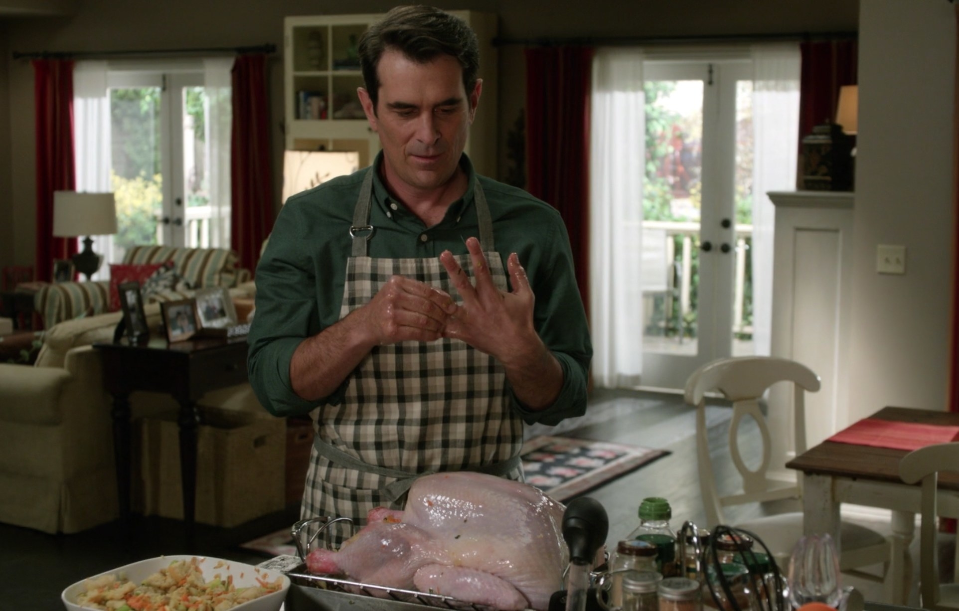 Phil taking off his wedding ring while cooking the turkey