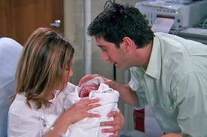 Ross and Rachel from Friends holding baby Emma in the hospital