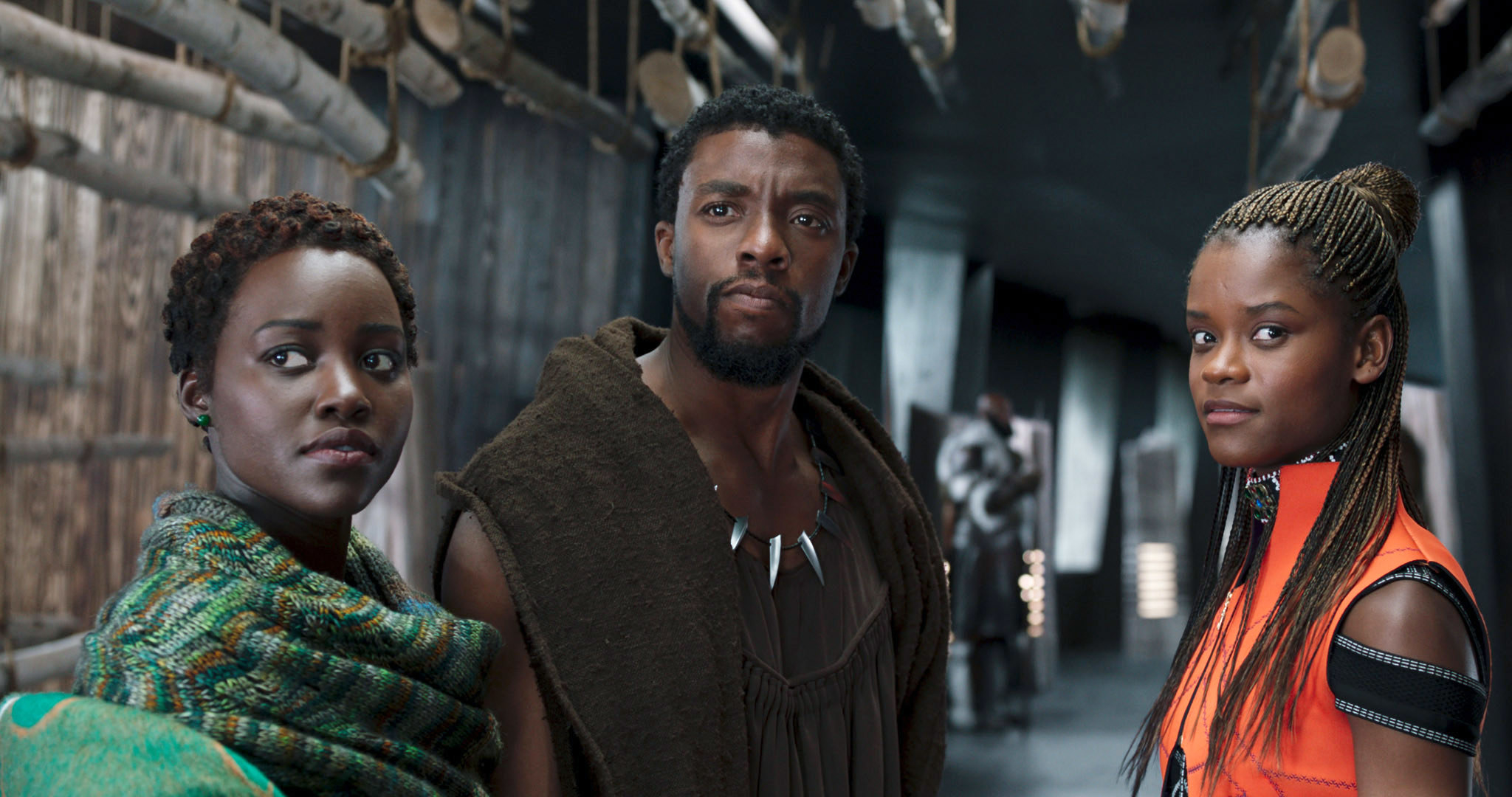 From left to right: Nakia, T&#x27;Challa, and Shuri looking off-screen