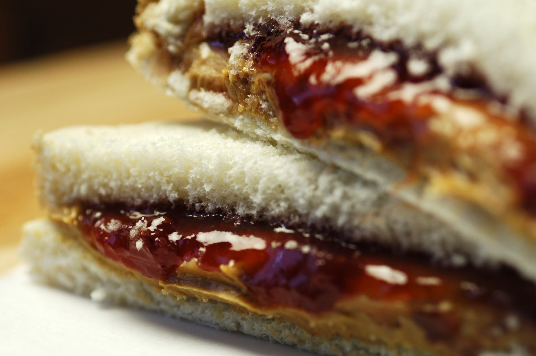 Close up of peanut butter and jelly sandwich on white bread