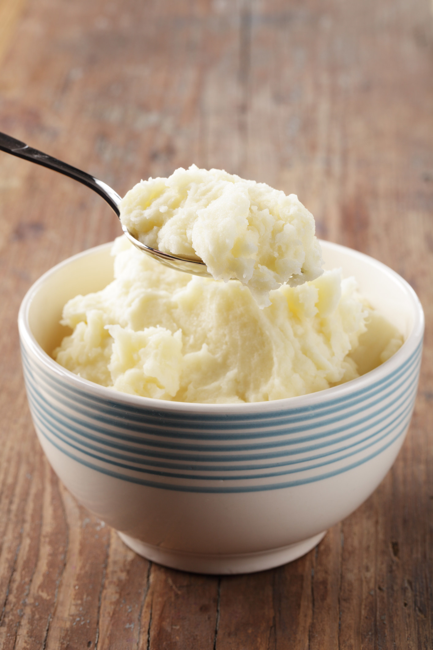 Taking a scoop of mashed potatoes from a bowl