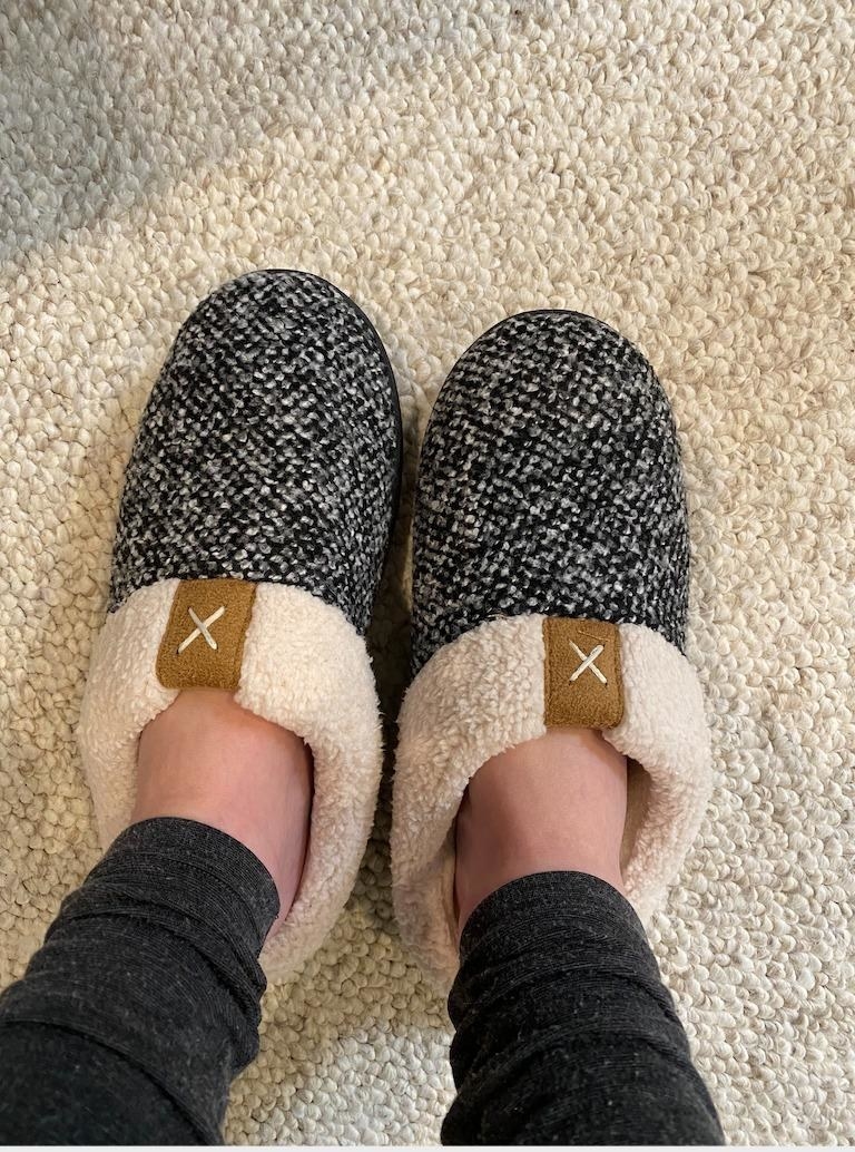Reviewers feet in the clog-style slippers in grey and cream