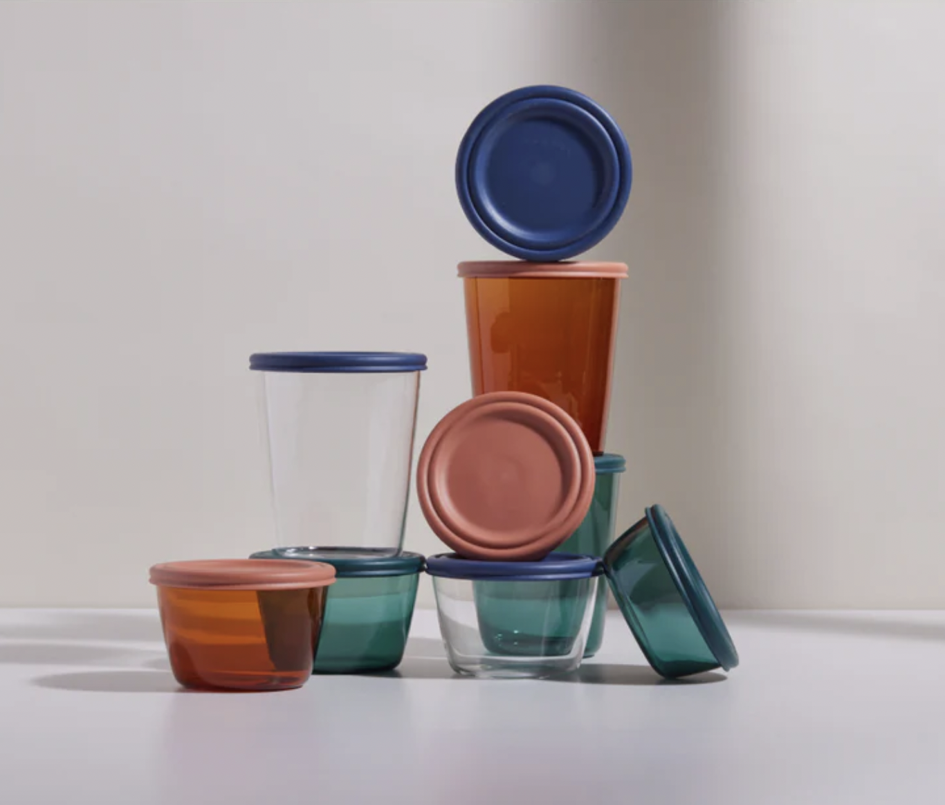 a set of colourful glass food containers stacked on top of one another