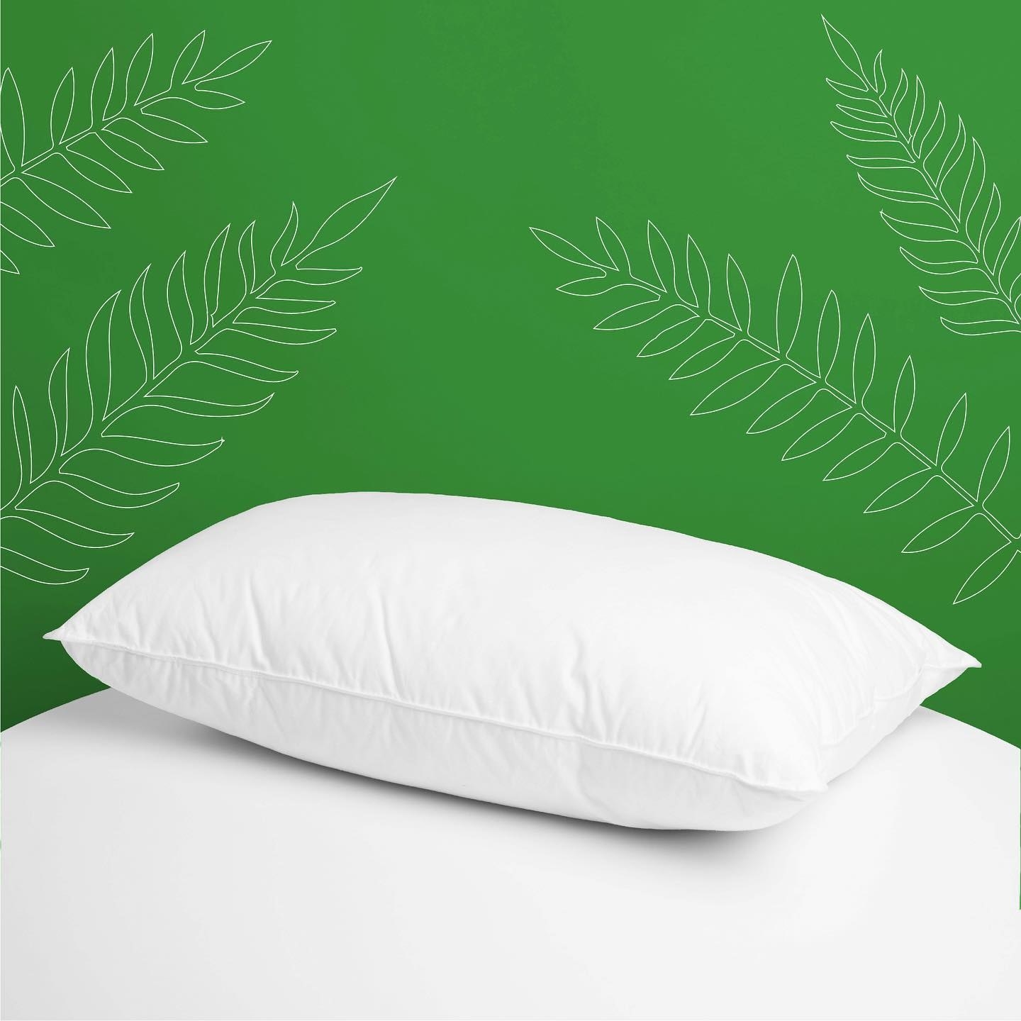 the pillow in front of a bright background with a leaf design