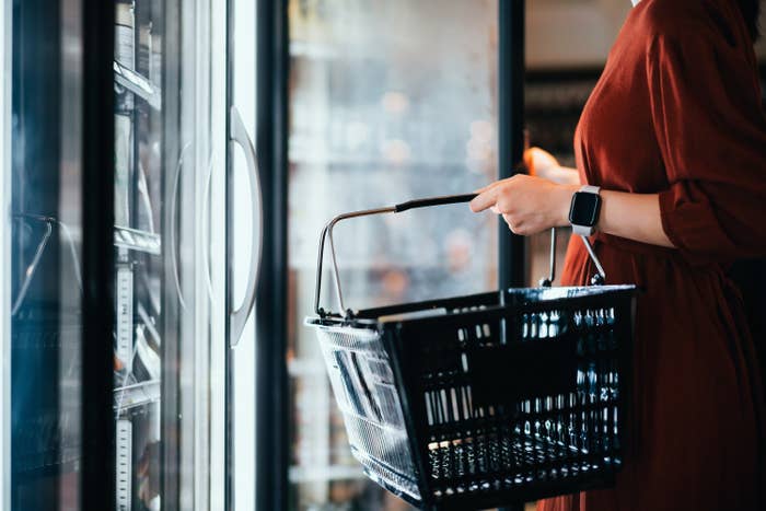 looking inside grocery freezer door with shopping basket