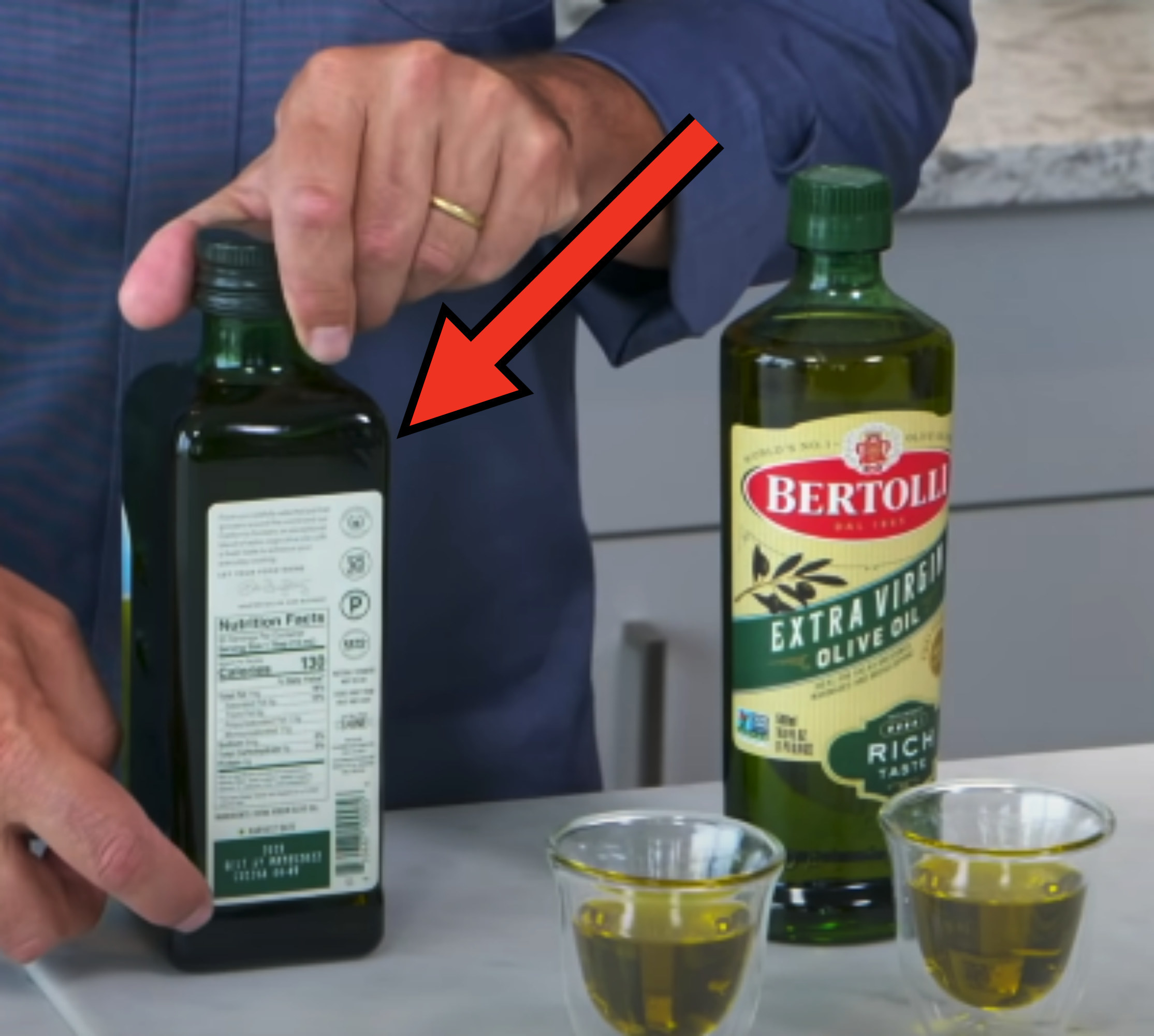 comparing two types of olive oil with arrow pointing to expensive one