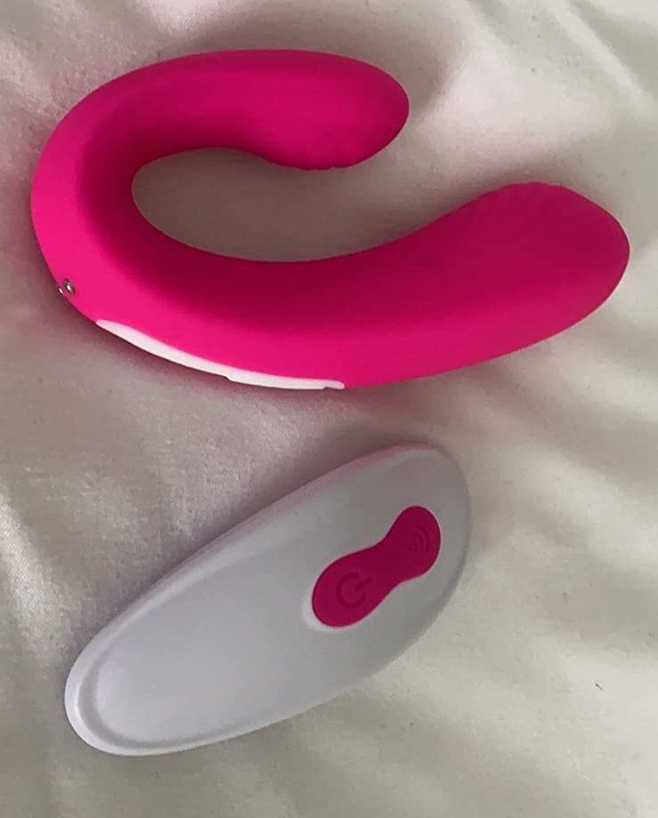 the oblong c-shaped vibrator in hot pink with remote