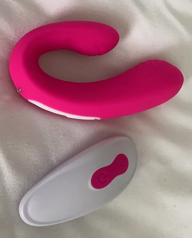 the oblong c-shaped vibrator in hot pink with remote