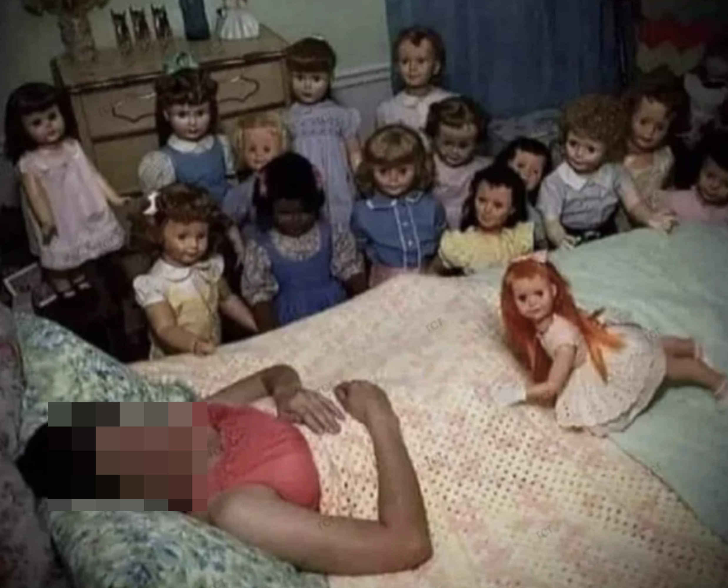 Someone sleeping in a room filled with dolls